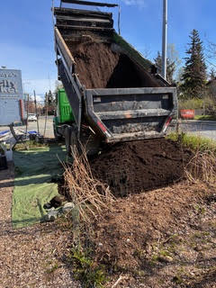 truck dumping topsoil
